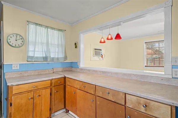 a kitchen with cabinets and window