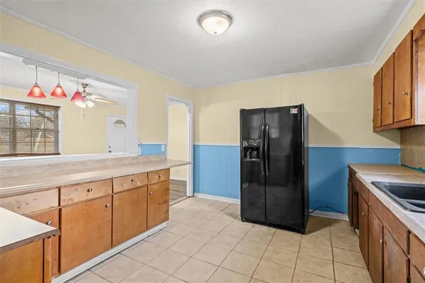 a kitchen with stainless steel appliances granite countertop a refrigerator and a sink