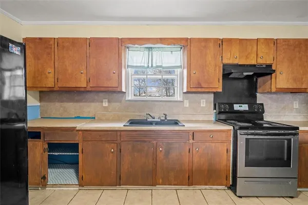 a kitchen with a stove and a sink