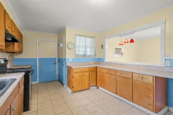 a kitchen with granite countertop a sink and a stove top oven