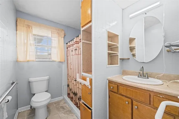 a bathroom with a toilet a sink and a large mirror