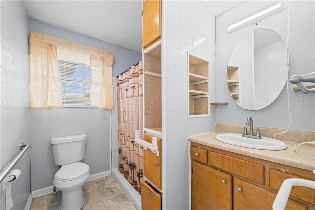 133 2nd Street Calhoun, GA 30701 - Photo 18 of 33 a bathroom with a toilet a sink and a large mirror