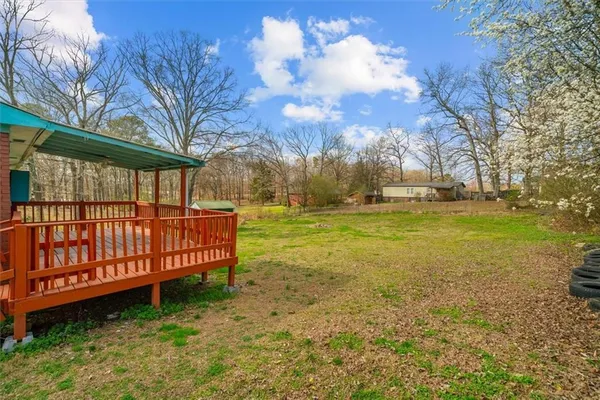 a view of a yard with large trees