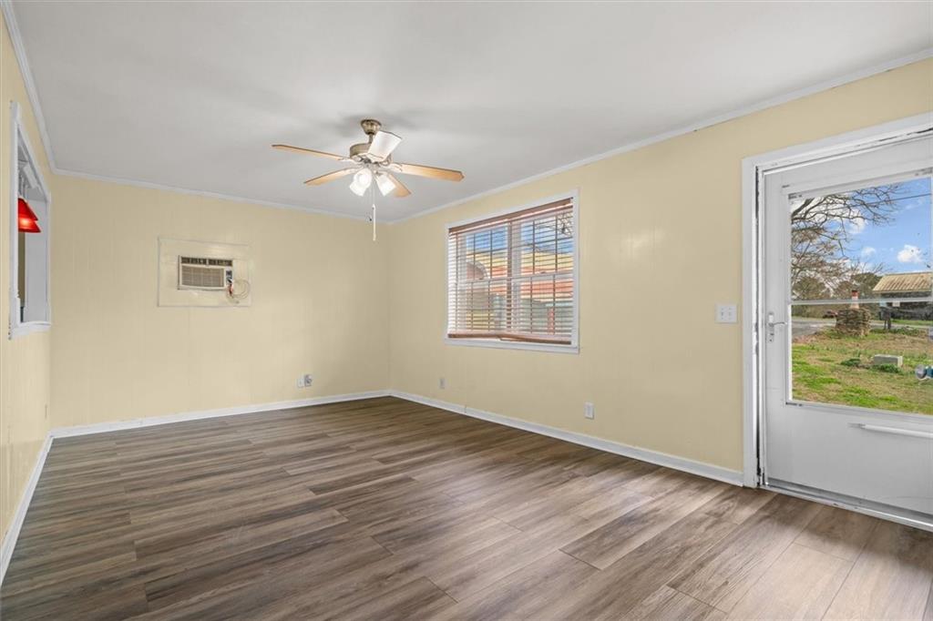 133 2nd Street Calhoun, GA 30701 - Photo 6 of 33 a view of an empty room with a window and wooden floor