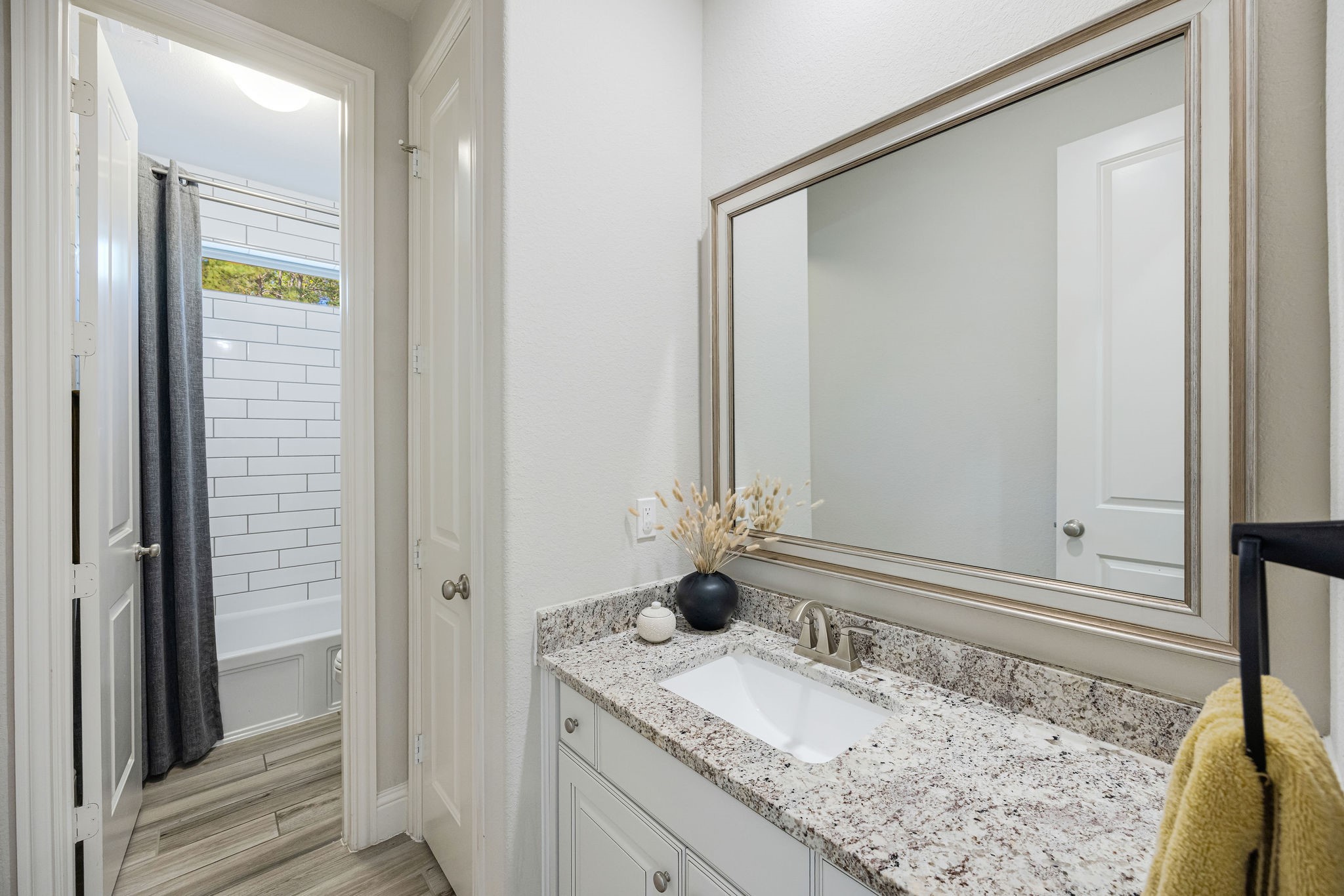 13103 Six Rivers Drive Humble, TX 77346 - Photo 18 of 44 Secondary bathroom with granite countertops, ceramic wood like tile, and ample storage.