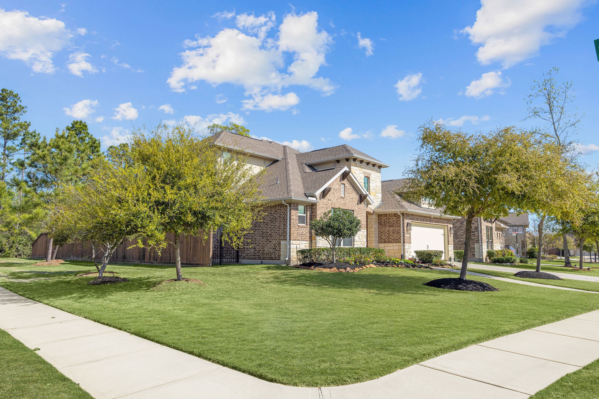 13103 Six Rivers Drive Humble, TX 77346 - Photo 2 of 44 Surrounded by trees with a sidewalk connecting to neighborhood trails. Ideal for outdoor enthusiasts.