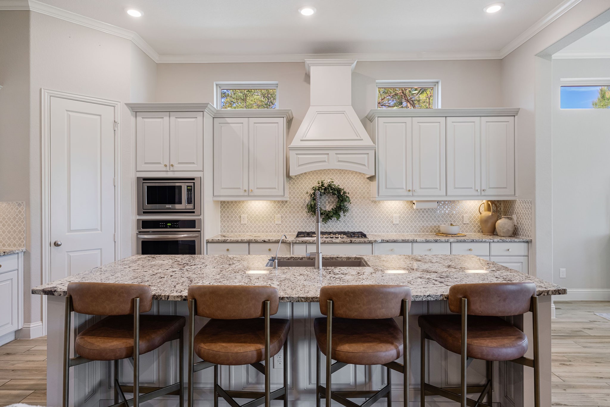 13103 Six Rivers Drive Humble, TX 77346 - Photo 4 of 44 Equipped with built-in stainless steel appliances, a statement range hood, gold hardware, under-cabinet lighting, recessed lighting, and a spacious walk-in pantry.