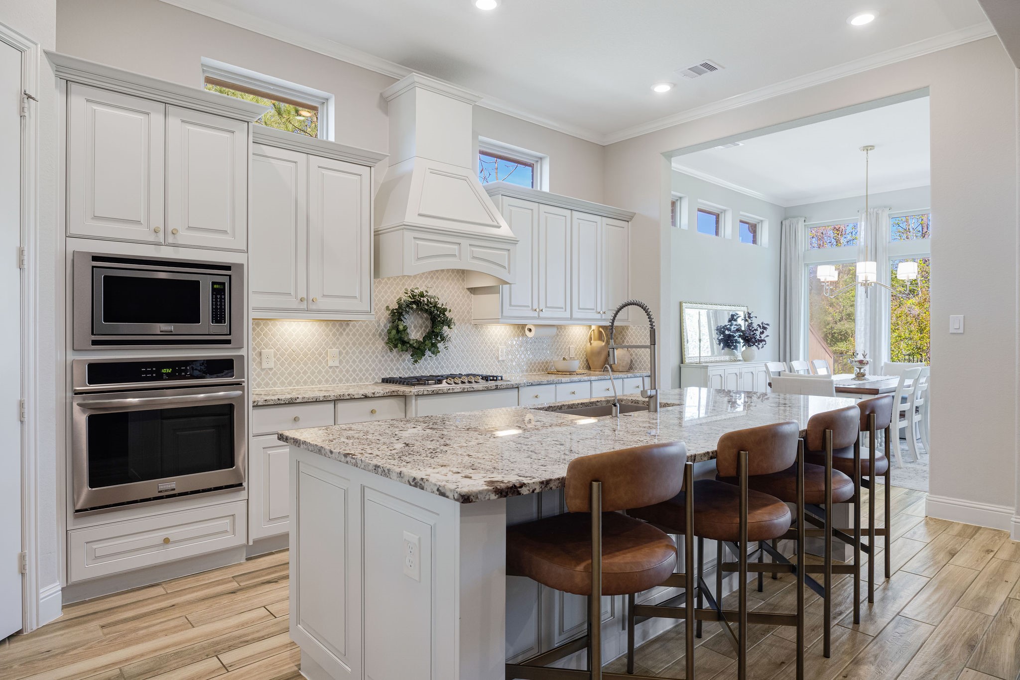 13103 Six Rivers Drive Humble, TX 77346 - Photo 5 of 44 A thoughtfully designed gourmet kitchen with no detail overlooked, featuring granite countertops, a tile backsplash, and custom French country cabinetry.