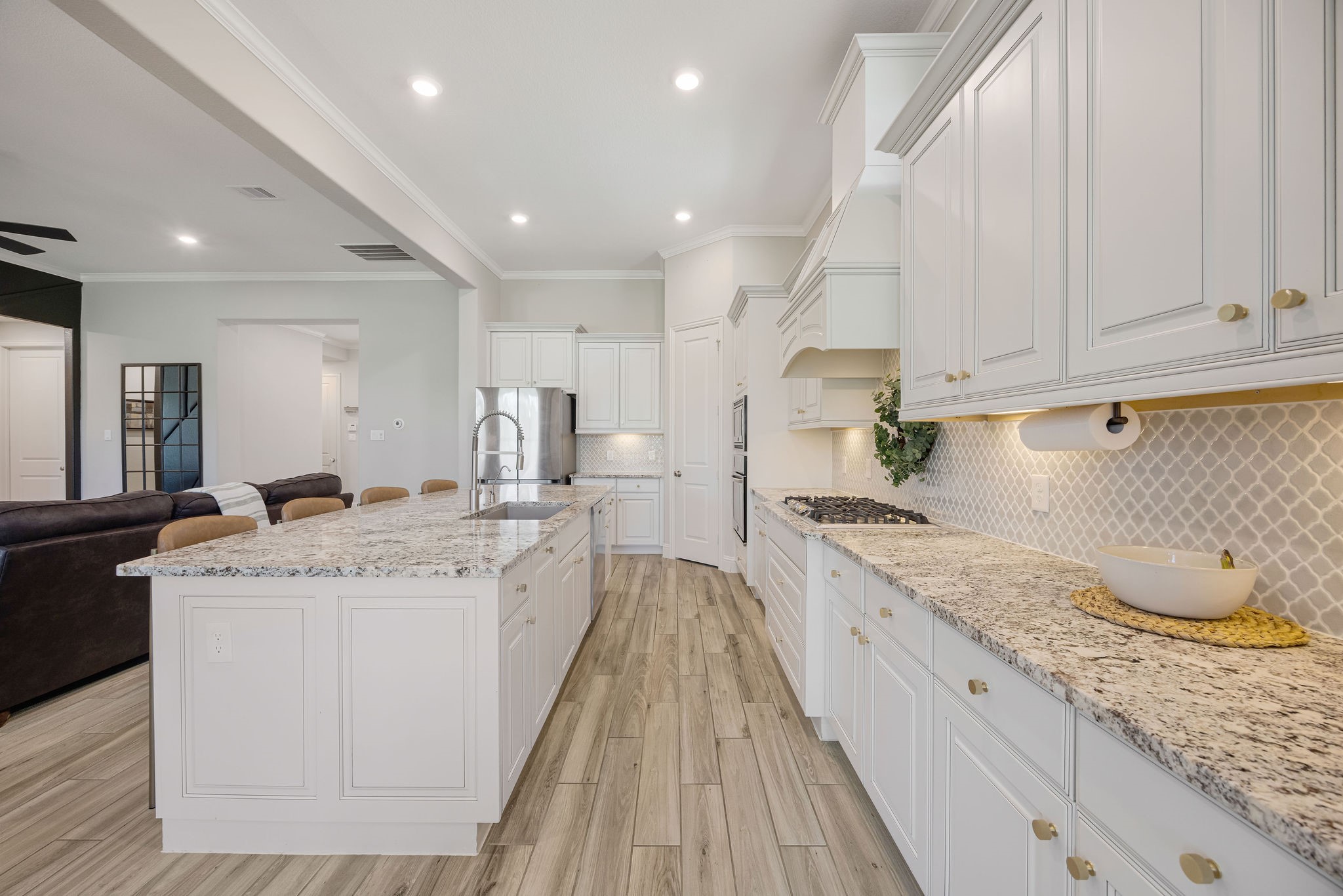 13103 Six Rivers Drive Humble, TX 77346 - Photo 7 of 44 Equipped with built-in stainless steel appliances, a statement range hood, gold hardware, under-cabinet lighting, recessed lighting, and a spacious walk-in pantry.