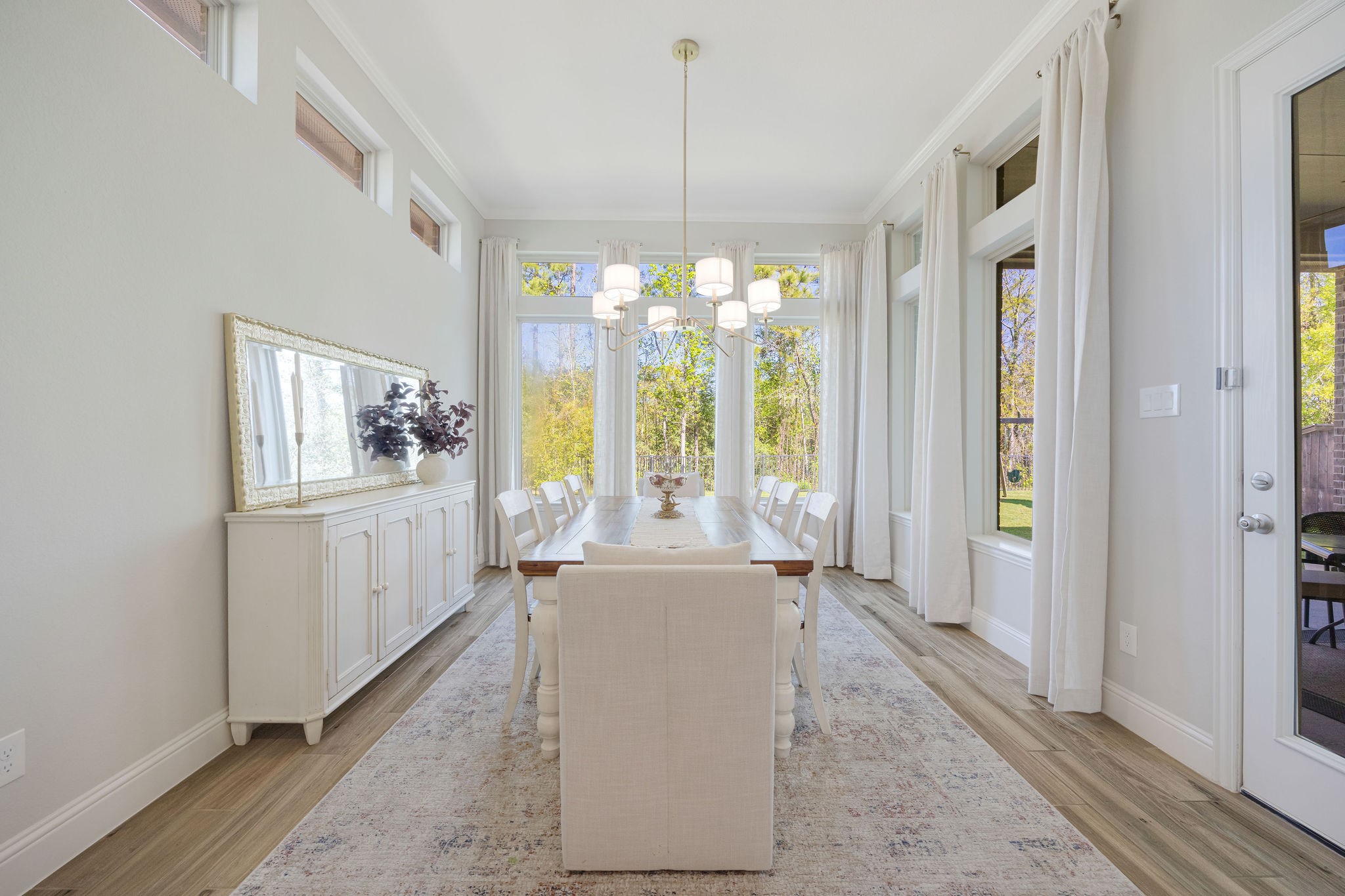 13103 Six Rivers Drive Humble, TX 77346 - Photo 8 of 44 The spacious dining room is designed for entertaining, offering an intimate setting with views of the tree-lined yard from every window.