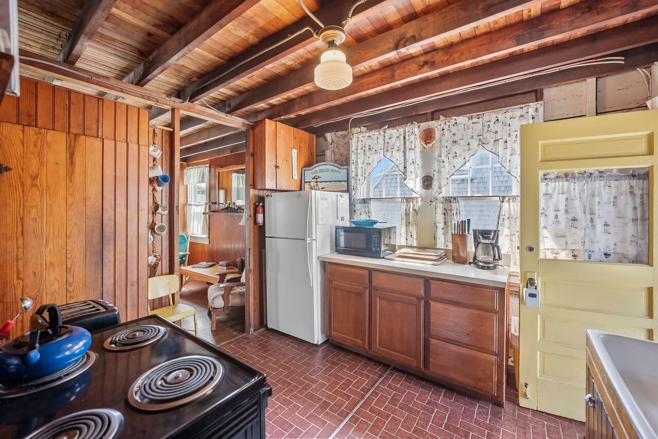 5 Spurr Road Pocasset, MA 02559 - Photo 13 of 42 a kitchen with stainless steel appliances granite countertop a sink stove and cabinets