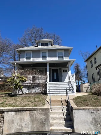 a front view of a house with shrubs