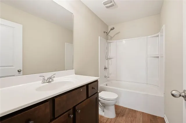 a bathroom with a sink vanity tub and shower