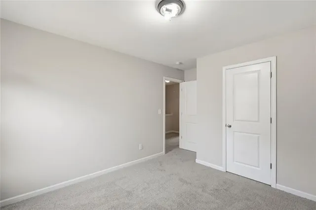 a living room with furniture a window and a flat screen tv