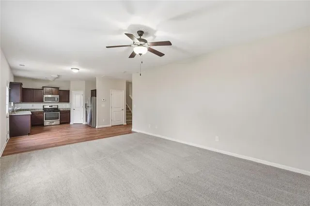 a kitchen with granite countertop a refrigerator and a sink