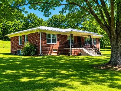 202 Maggart Road Elmwood, TN 38560 - Photo 1 of 34 a front view of a house with a yard table and chairs