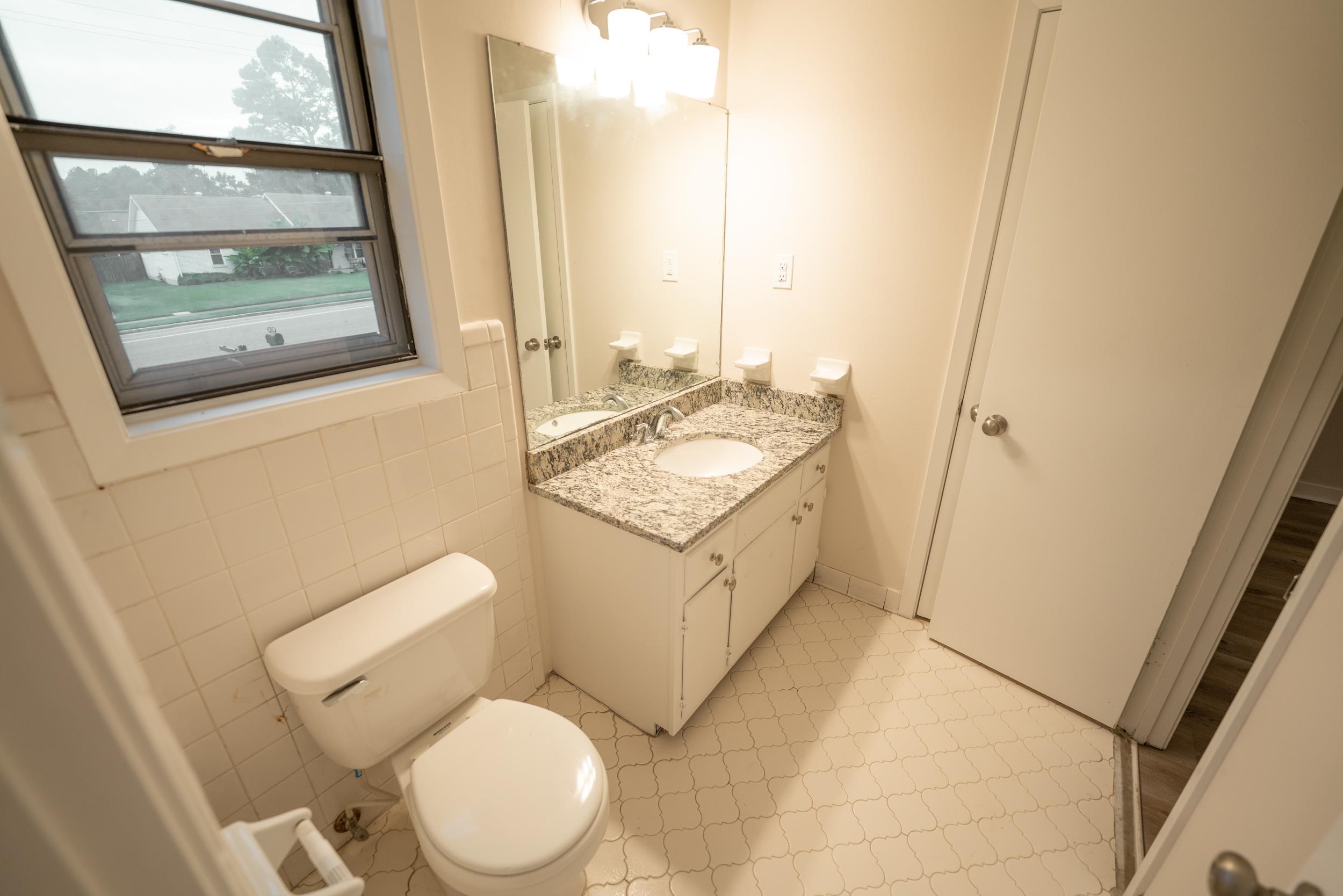 3054 Altruria Road Bartlett, TN 38134 - Photo 11 of 22 a white toilet sitting next to a bathroom sink