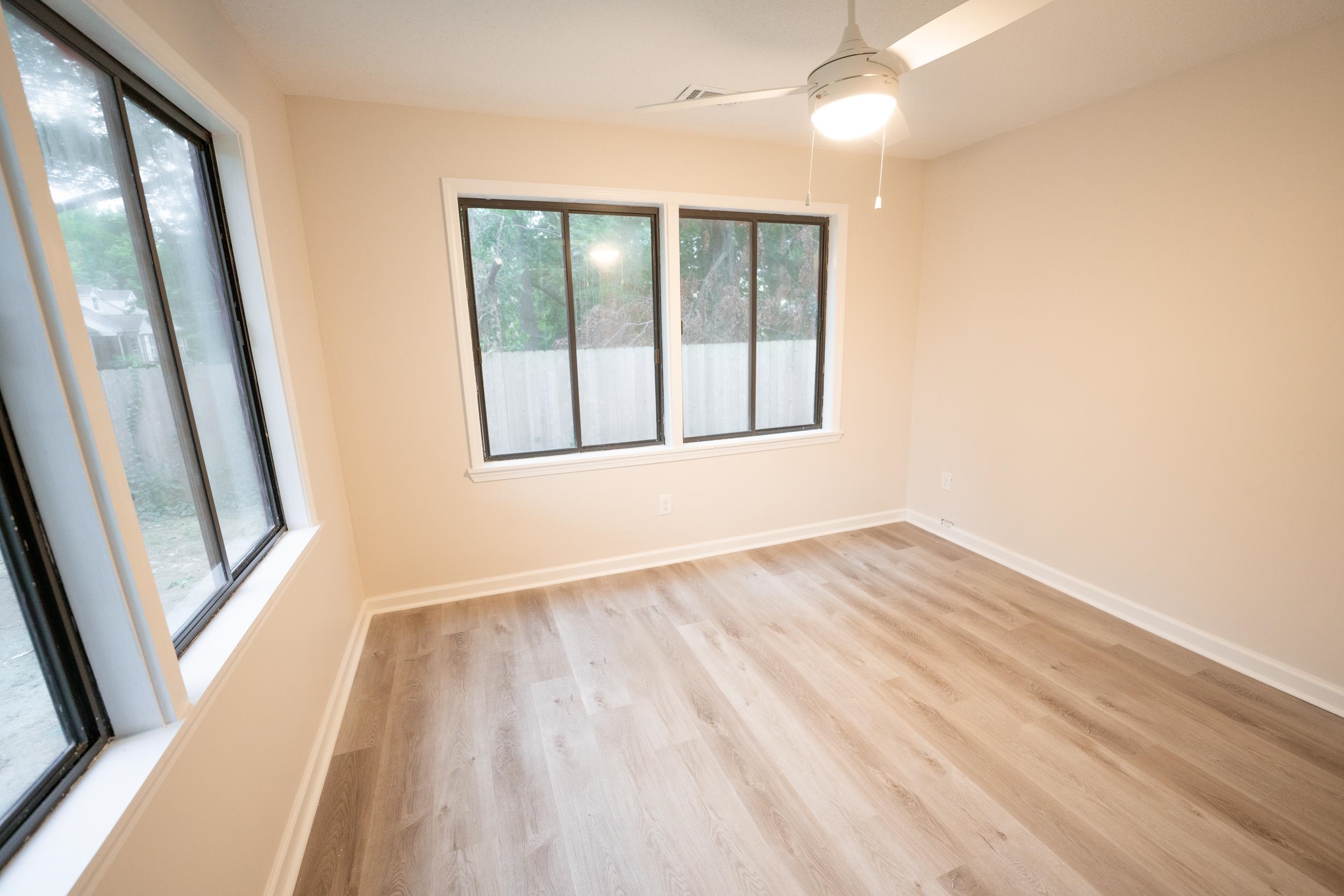 3054 Altruria Road Bartlett, TN 38134 - Photo 12 of 22 a view of an empty room with wooden floor and a window