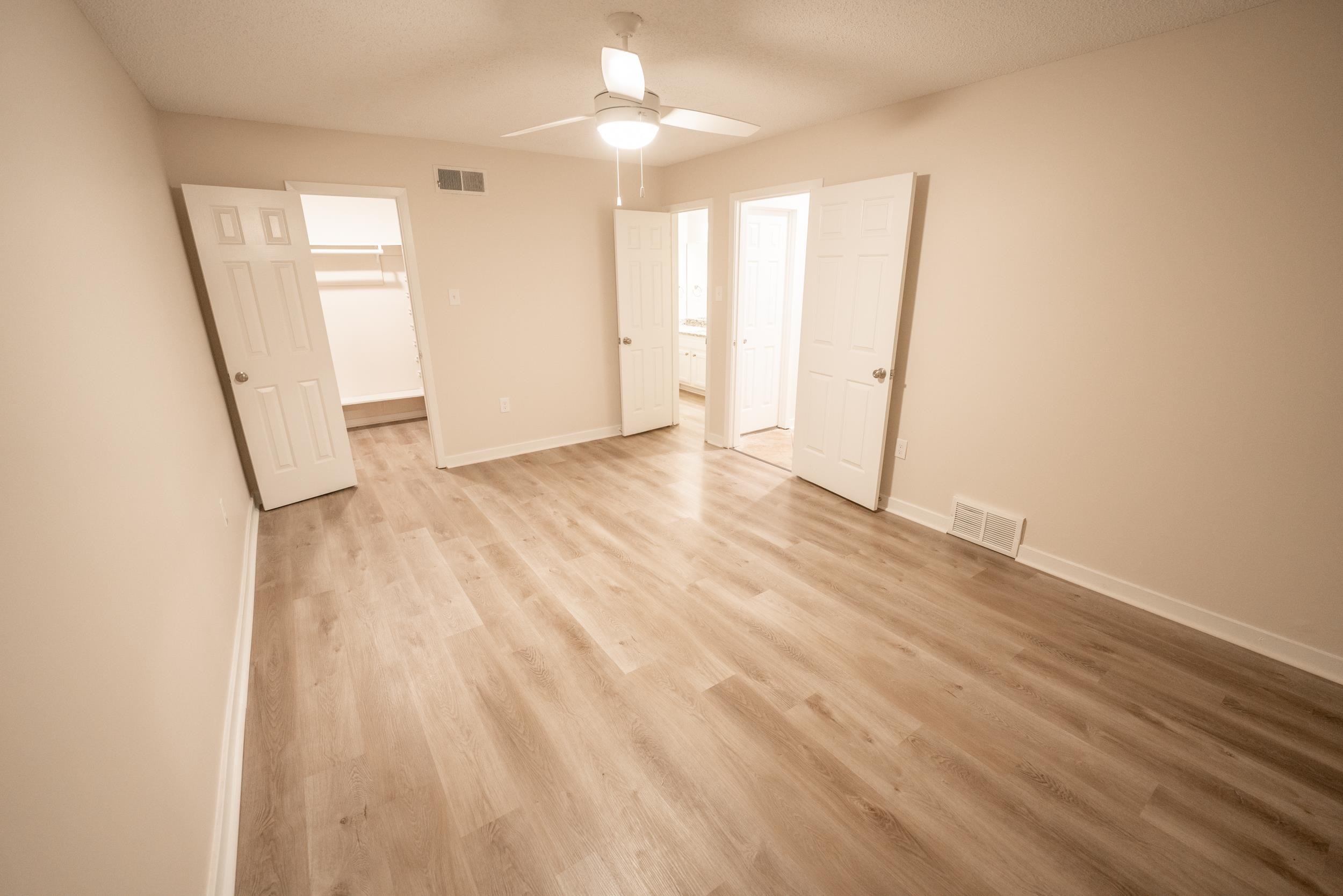 3054 Altruria Road Bartlett, TN 38134 - Photo 16 of 22 an empty room with wooden floor and windows