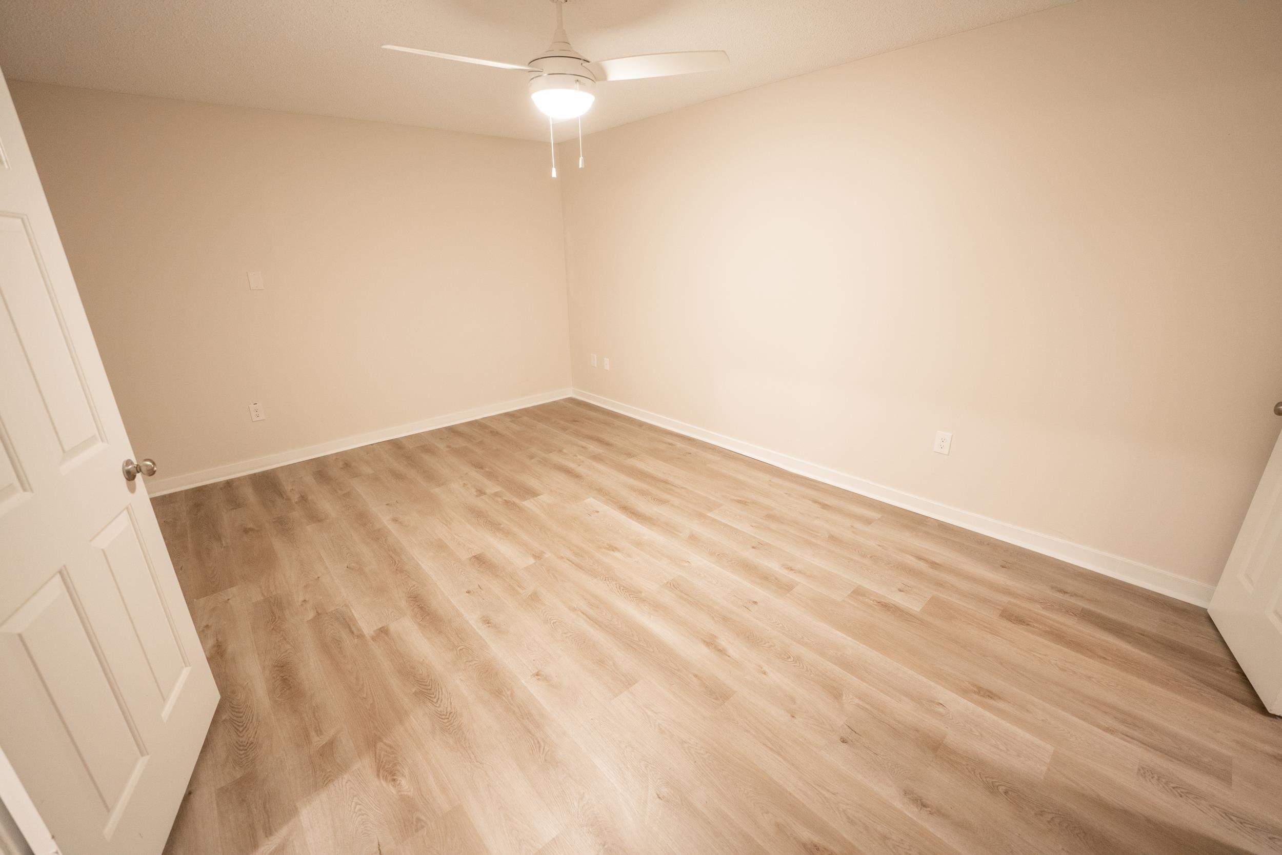 3054 Altruria Road Bartlett, TN 38134 - Photo 19 of 22 an empty room with wooden floor fan and window