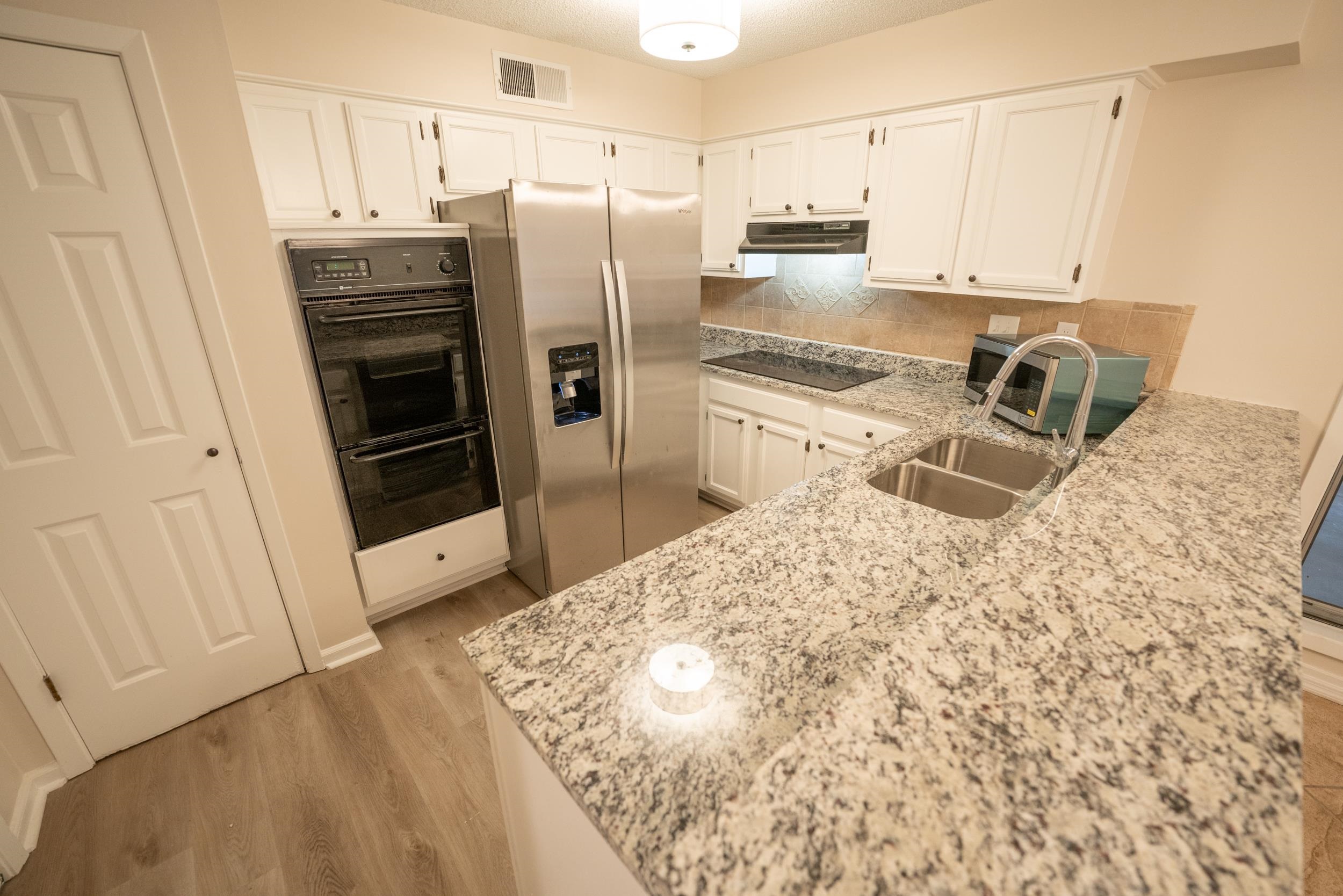 3054 Altruria Road Bartlett, TN 38134 - Photo 2 of 22 a kitchen with granite countertop a refrigerator sink and stove