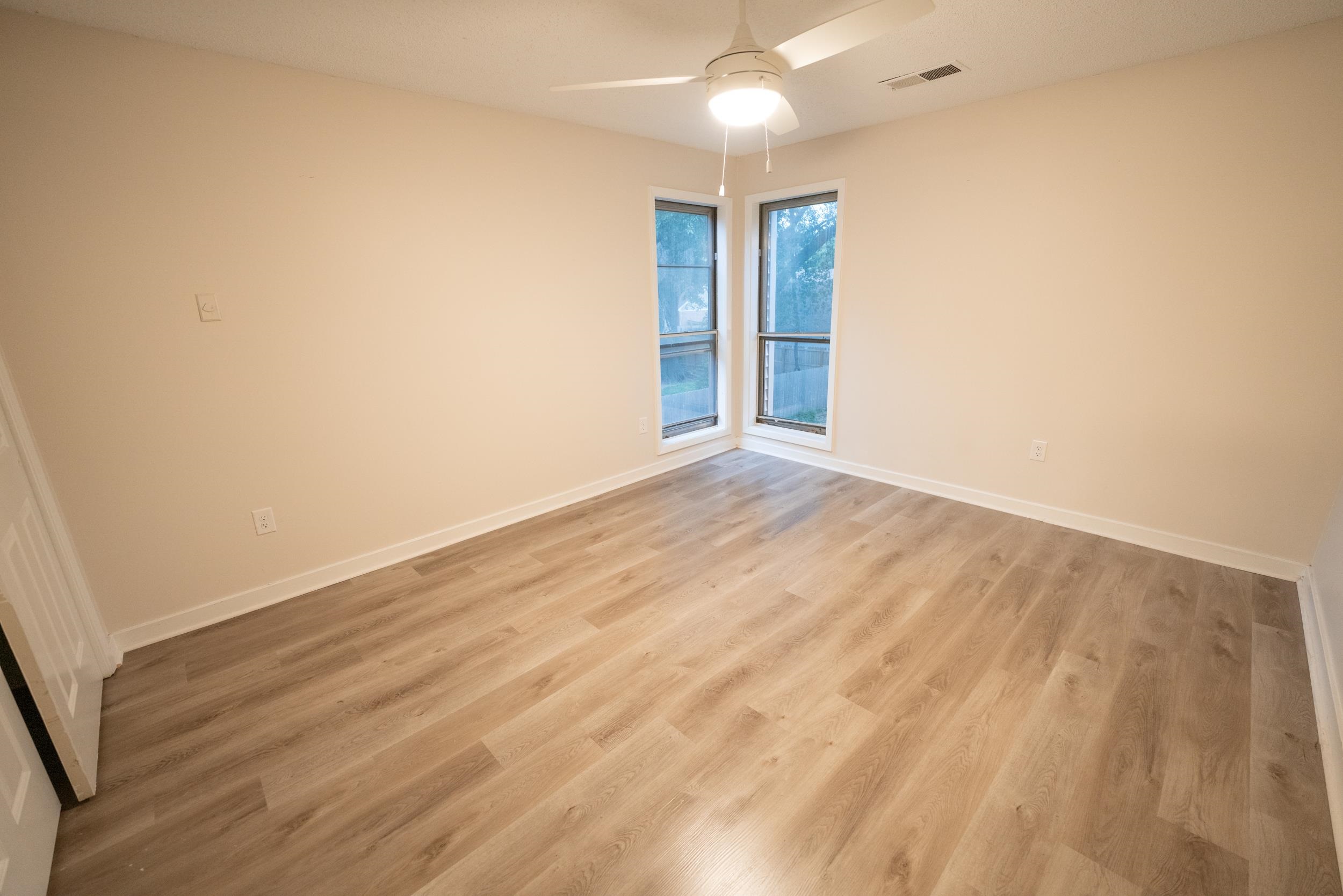 3054 Altruria Road Bartlett, TN 38134 - Photo 5 of 22 an empty room with wooden floor and windows
