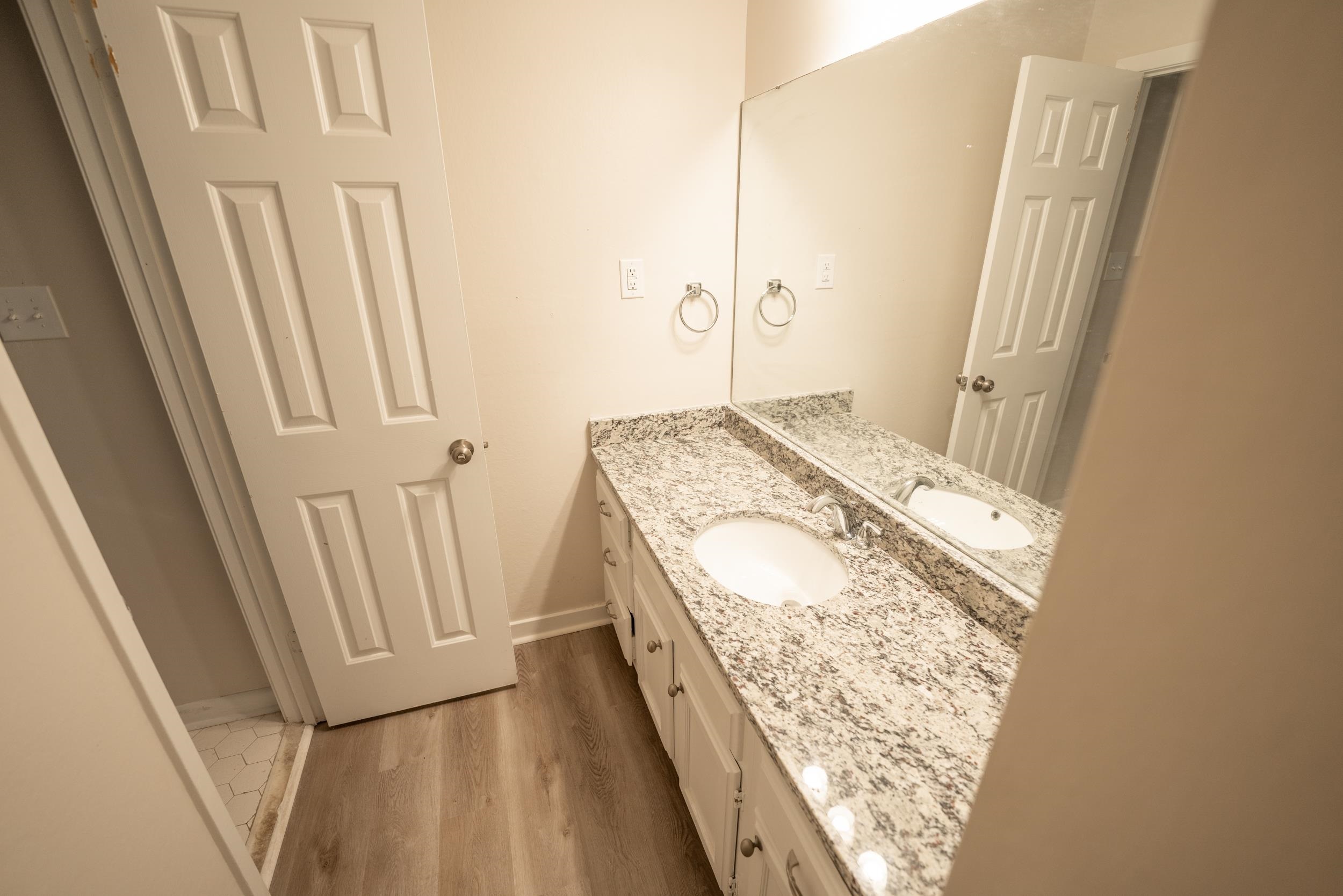 3054 Altruria Road Bartlett, TN 38134 - Photo 7 of 22 a bathroom with a granite countertop sink and a mirror