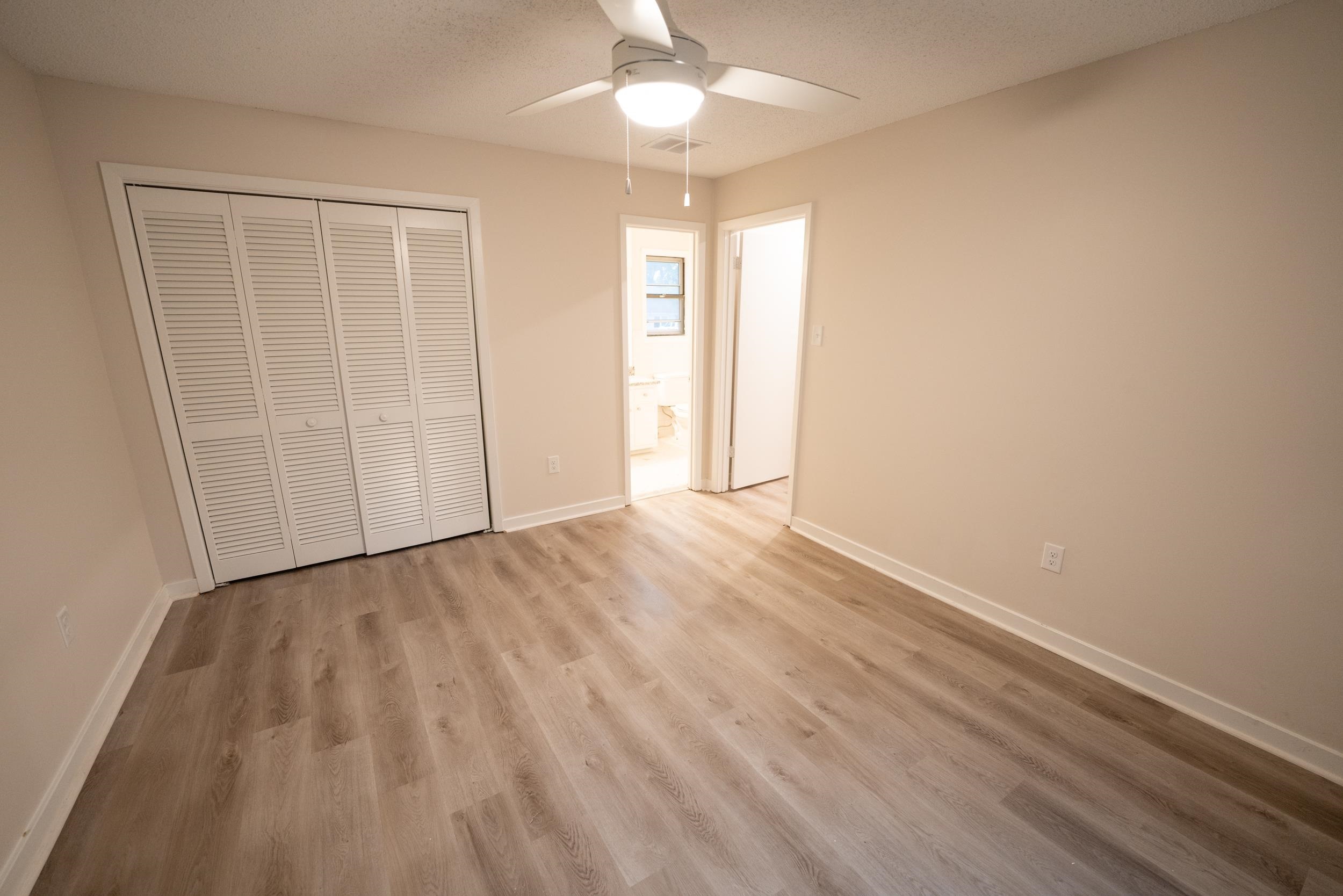 3054 Altruria Road Bartlett, TN 38134 - Photo 8 of 22 an empty room with wooden floor and windows