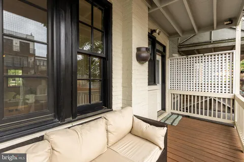 a view of a balcony with door and glass door