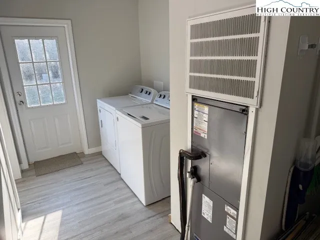 a view of a storage and utility room with a washer dryer