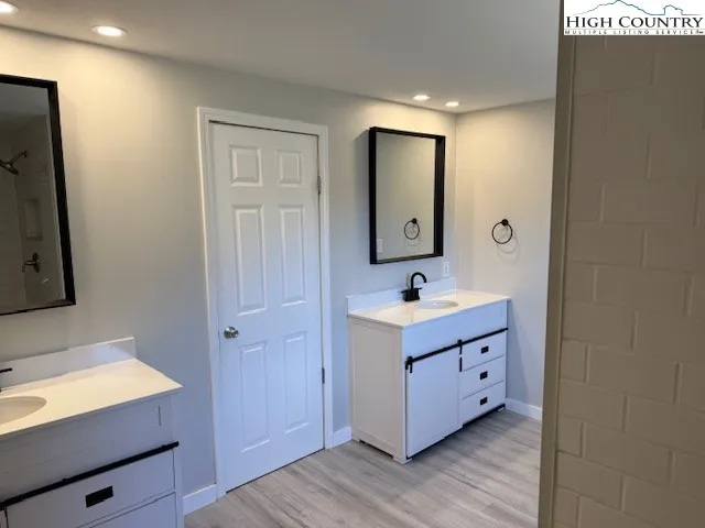a bathroom with a sink vanity and mirror
