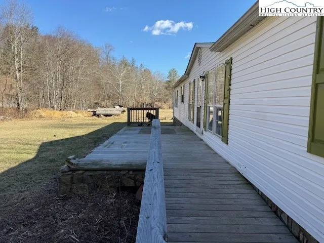 a view of a patio with wooden floor and a yard