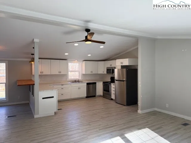 a kitchen with a refrigerator and a sink