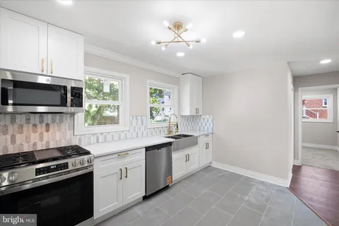 a kitchen with a stove oven and sink