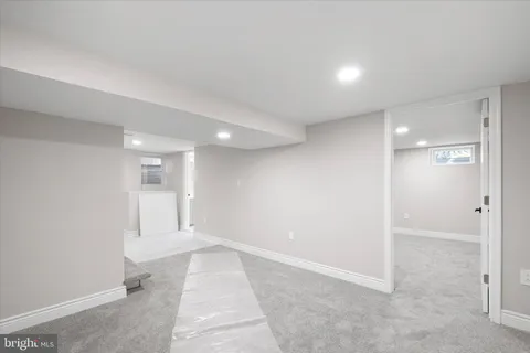 wooden floor in an empty room with a bathroom