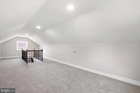 an empty room with closet and windows