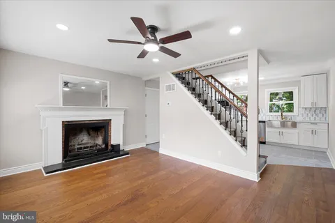 a view of a livingroom and a fireplace with wooden floor