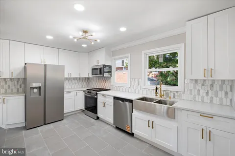 a kitchen with stainless steel appliances granite countertop a refrigerator sink and cabinets