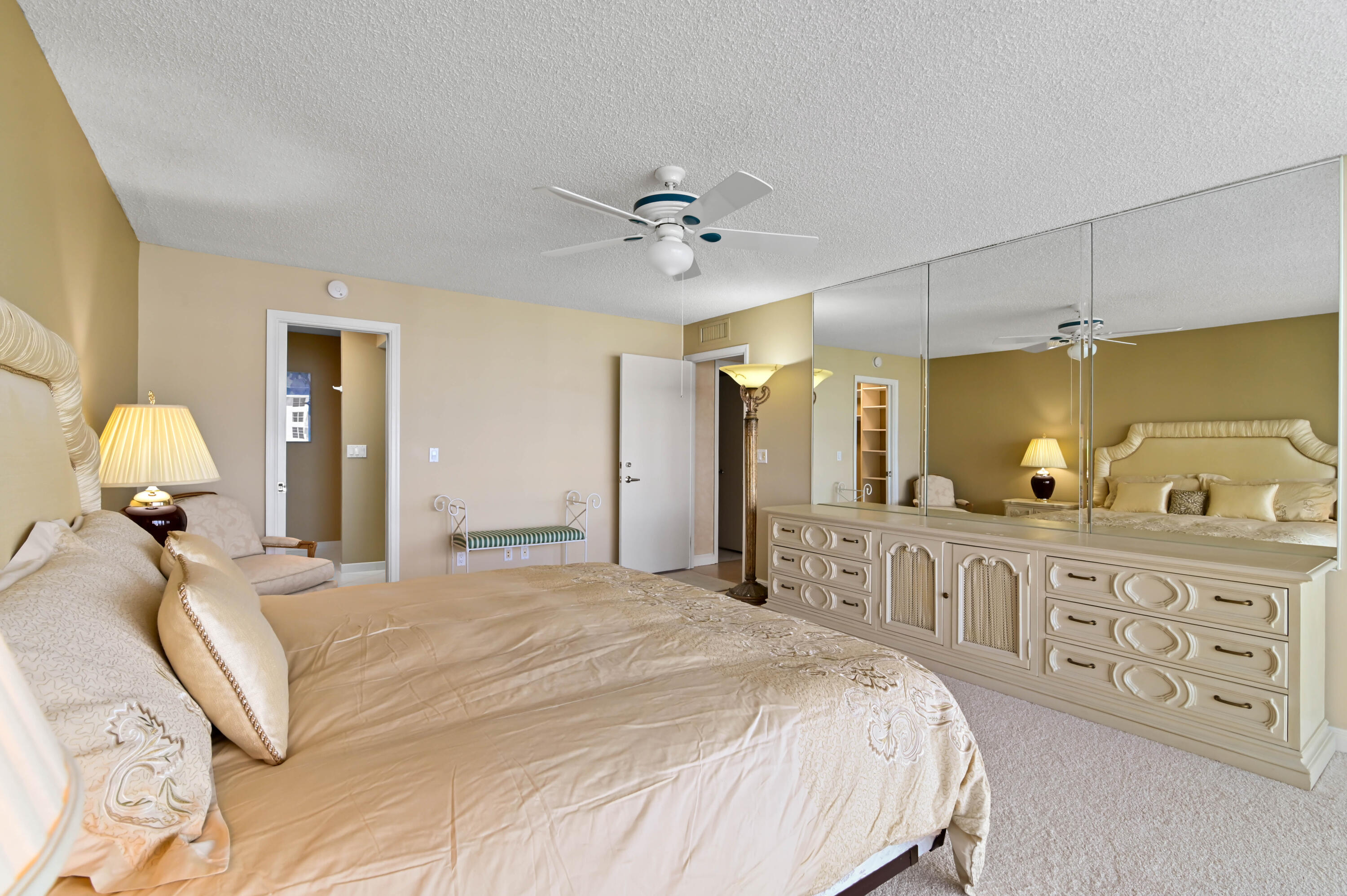2800 South Ocean Boulevard, Unit 5J Boca Raton, FL 33432 - Photo 17 of 56 a bedroom with a large bed and a chandelier