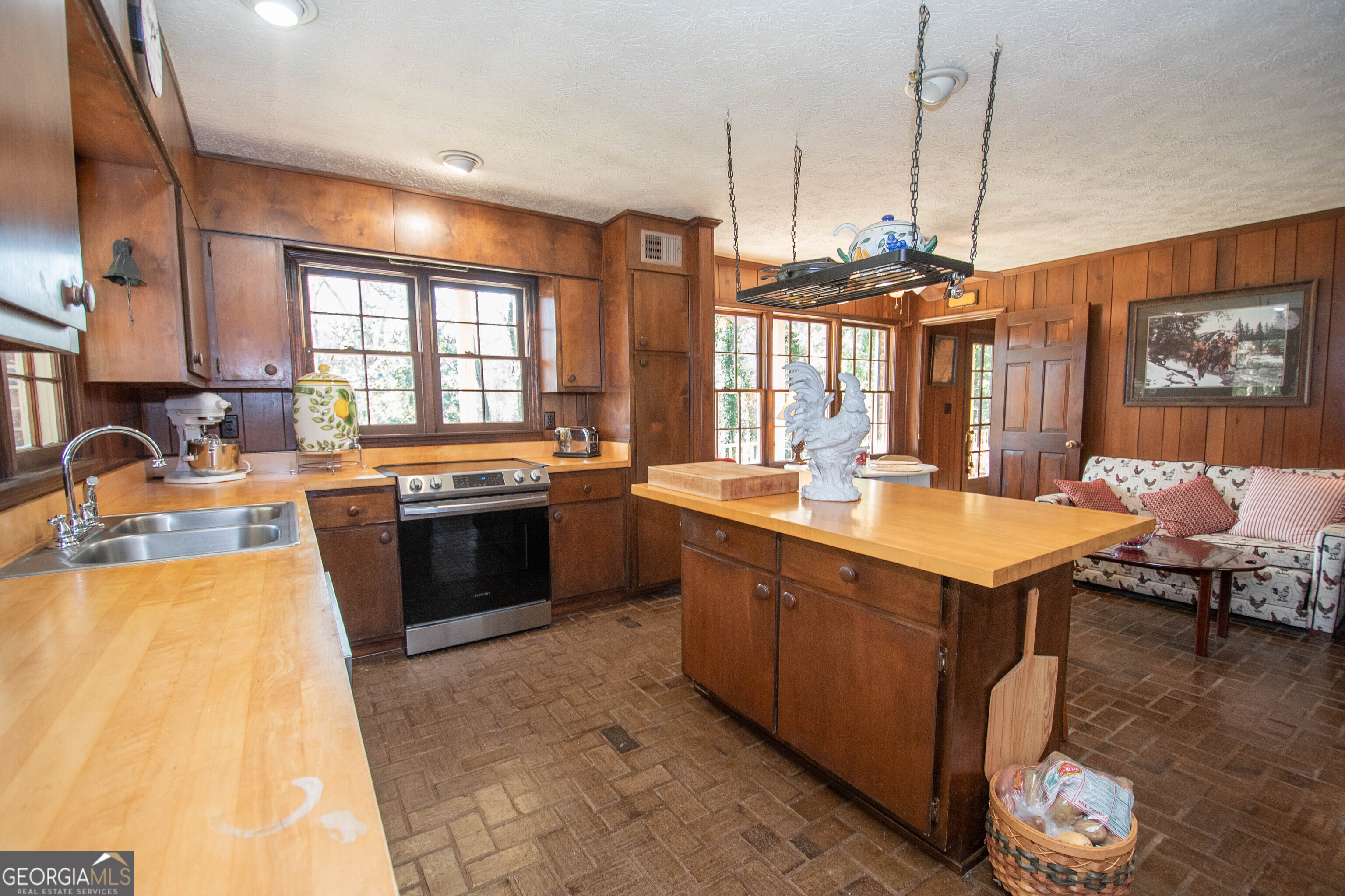 151 Evans Road Milner, GA 30257 - Photo 7 of 53 a large kitchen with a large counter top space a sink stainless steel appliances and cabinets