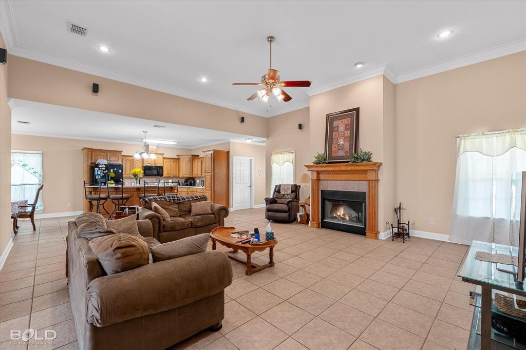 129 Wax Wing Drive Stonewall, LA 71078 - Photo 14 of 40 a living room with furniture a fireplace and a chandelier