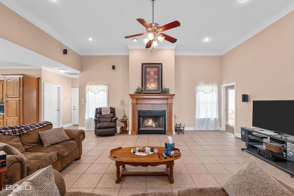 129 Wax Wing Drive Stonewall, LA 71078 - Photo 16 of 40 a living room with furniture a fireplace and a flat screen tv