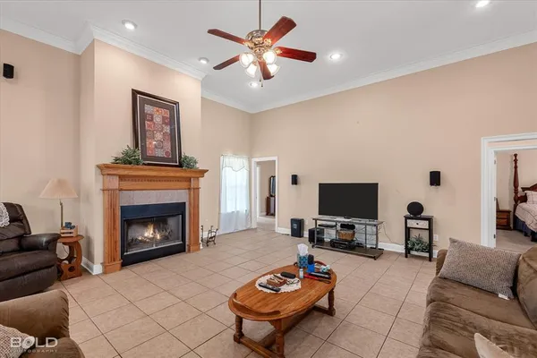 a living room with furniture a fireplace and a flat screen tv