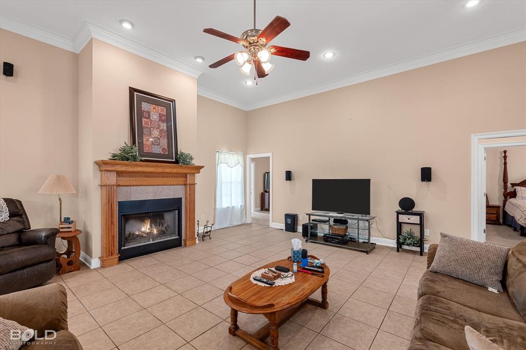 129 Wax Wing Drive Stonewall, LA 71078 - Photo 20 of 40 a living room with furniture a fireplace and a flat screen tv
