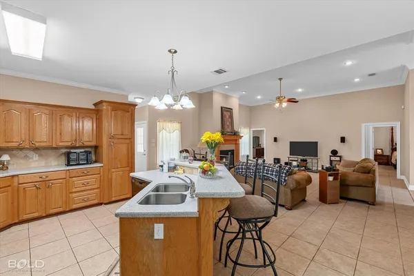 a kitchen with stainless steel appliances kitchen island granite countertop a sink and cabinets