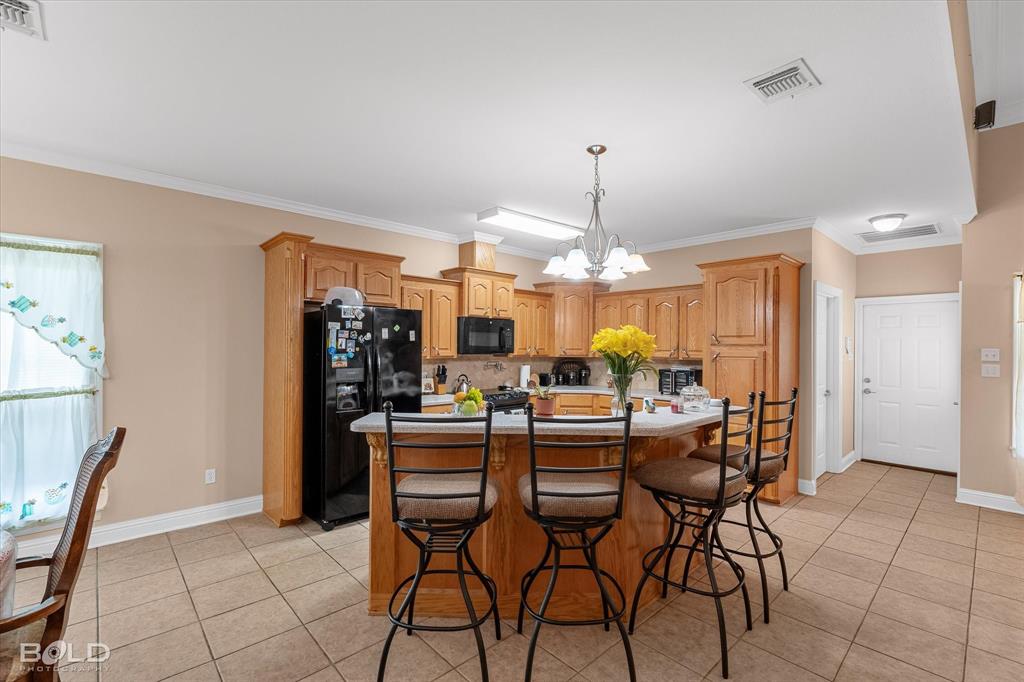 129 Wax Wing Drive Stonewall, LA 71078 - Photo 27 of 40 a view of a dining room with furniture and chandelier