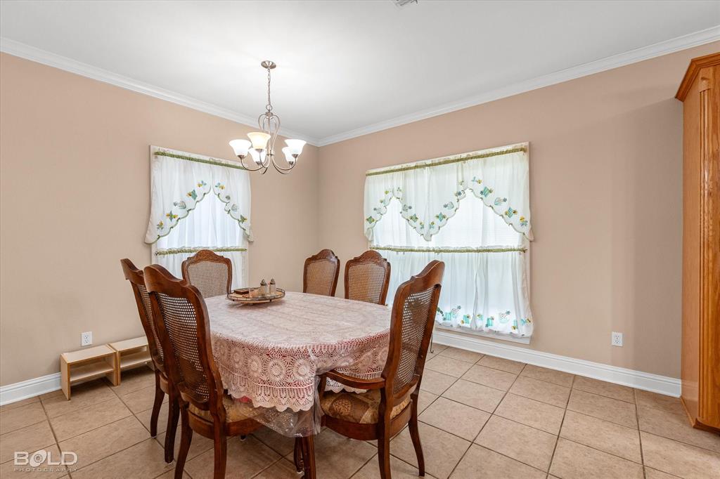 129 Wax Wing Drive Stonewall, LA 71078 - Photo 28 of 40 a view of a dining room with furniture window and outside view