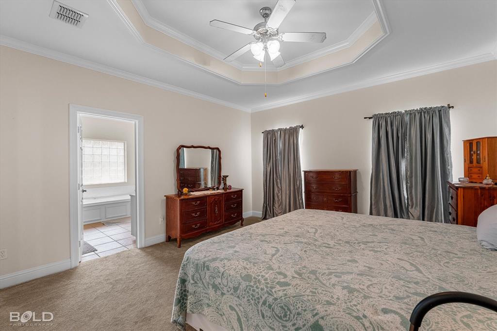 129 Wax Wing Drive Stonewall, LA 71078 - Photo 29 of 40 a bedroom with a large bed and dresser