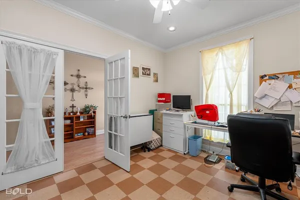 a view of a workspace with furniture and a window
