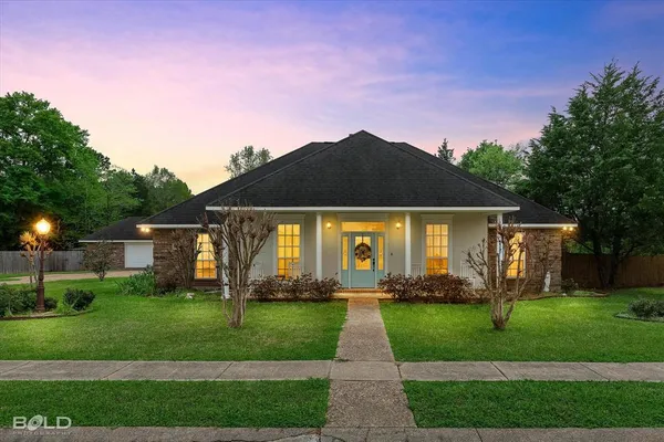 a front view of house with yard and green space